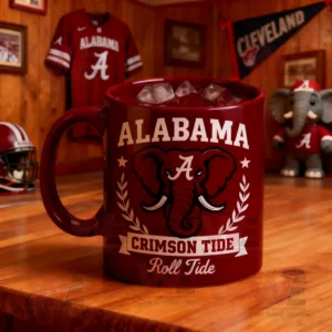 A red mug with the Alabama Crimson Tide logo featuring an elephant and the words Roll Tide on a wooden table!