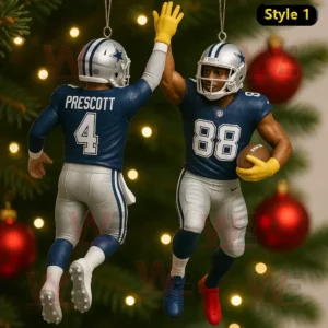 Two Dallas Cowboys football players in blue uniforms high fiving as Christmas ornaments on a tree.