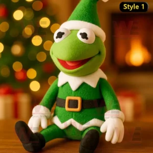 Kermit the Frog dressed as an elf, sitting in front of a Christmas tree.