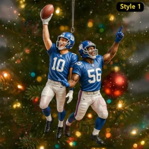 Two New York Giants football players celebrating with a raised football as Christmas ornaments on a tree.