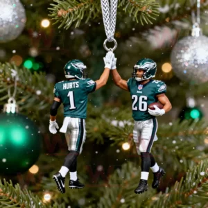 Two Philadelphia Eagles player ornaments high fiving on a decorated Christmas tree.