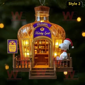 Golden bottle ornament labeled Donald’s Holiday Spirit with Snoopy sitting on a porch.