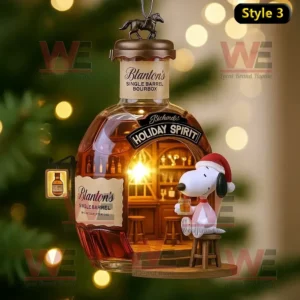 Snoopy sitting on a bar stool beside a glowing Blanton’s Holiday Spirit bottle ornament.