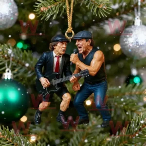 A Christmas ornament featuring two rock musicians performing on stage represented as miniature figures hanging on a decorated tree!