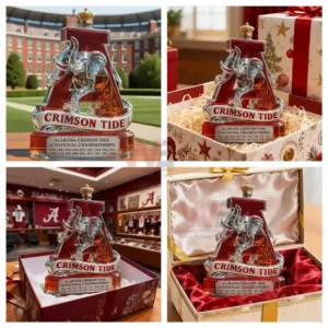 The image shows an ornate Alabama Crimson Tide bottle trophy featuring a silver elephant mounted on a red A emblem positioned outdoors on a wooden surface!