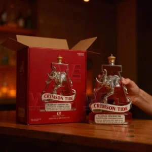 Alabama Crimson Tide National Champions Whiskey Bottle 7 The image displays an Alabama Crimson Tide bottle laying in a red box with white padding among various wrapped Christmas presents!