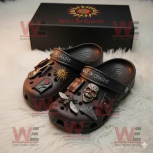 Alice In Chains Crocs with skull and sun charms in front of branded box on white fur surface!