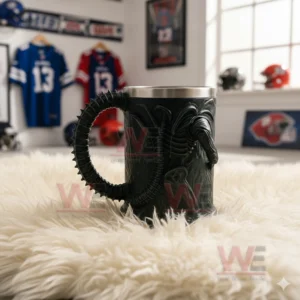Alien 3D Sci-Fi Monster Stainless Steel Cup 5 The back view of a sculpted alien mug with a ridged tail handle placed on a white fluffy rug inside a sports themed space!