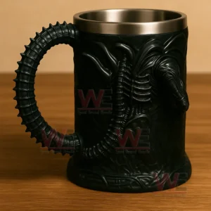 Alien 3D Sci-Fi Monster Stainless Steel Cup 7 The rear side of a black alien themed mug featuring a long textured tail handle displayed on a wooden tabletop!