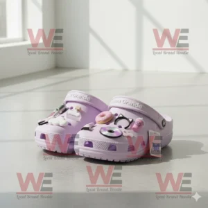 Ariana Grande Crocs Clogs with Charms 8 Lavender Crocs with Ariana Grande logo and multiple charms on white furry rug!