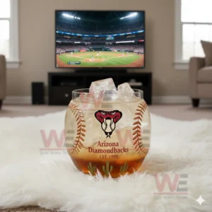 Arizona Diamondbacks baseball whiskey glass filled with ice, sitting on a rug with a baseball game showing on the TV in the background.