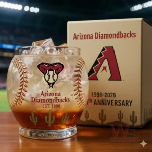Arizona Diamondbacks 28th Anniversary Whiskey Glass 3 Arizona Diamondbacks anniversary whiskey glass with ice, next to a box celebrating their 28th anniversary, in front of a baseball stadium.