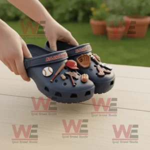 Atlanta Braves MLB Crocs Clogs With Charms 8 Atlanta Braves themed Crocs with baseball and food charms held above wooden table outdoors!