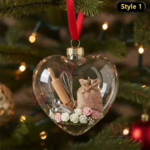 Alt text: A close-up of a heart-shaped ornament filled with miniature baking tools like a rolling pin and whisk, with pink roses.