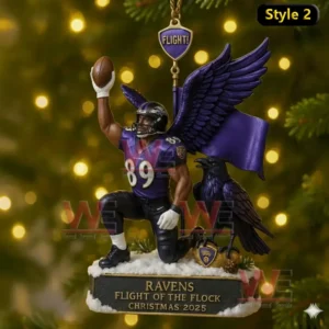 A Baltimore Ravens themed Christmas ornament featuring a number 89 player with wings kneeling on snow while raising a football, accompanied by a raven and a purple flag.