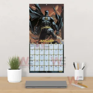 Batman 2026 Wall Calendar 10 A wall mounted calendar with the dark hero displayed above a desk setup!