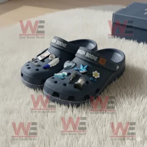 Benson Boone Crocs Clogs with Charms 6 Navy Crocs with Benson Boone charms displayed on a light carpet beside a blue shoe box.