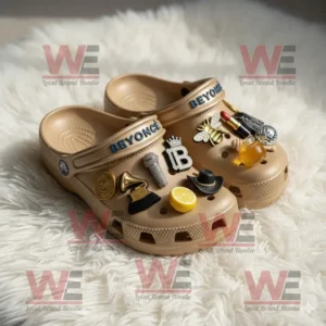 Beyonce Crocs Clogs with Charms 6 Beige Crocs with Beyonce charms displayed on a fluffy light carpet.