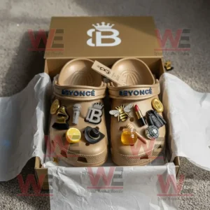 Beyonce Crocs Clogs with Charms 7 Beige Beyonce Crocs with charms arranged in an open golden box.