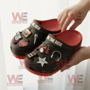 Big Time Rush Crocs Clogs with Charms 8 Hands holding Big Time Rush Crocs with detailed charms in black and red design.