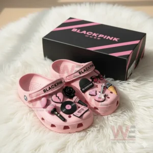 Pink BLACKPINK Crocs with charms like a microphone, guitar, and vinyl record.