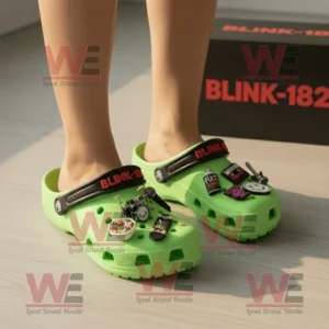Blink 182 Crocs Clogs with Charms 8 Person wearing neon green Blink-182 Crocs with punk rock charms indoors.