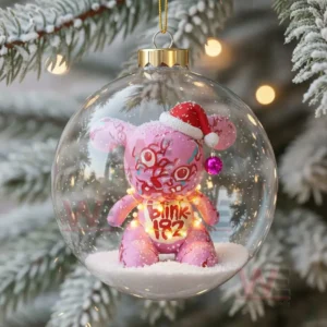 Blink 182 Rock Band Christmas Ornament 2025 11 A clear ornament showing a lit pink bear figure wearing a Santa hat placed in snow on a winter branch!
