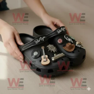 Bob Dylan Crocs Clogs With Charms 8 Bob Dylan Crocs being taken from the box by hands showing multiple musician inspired charms under soft natural light!