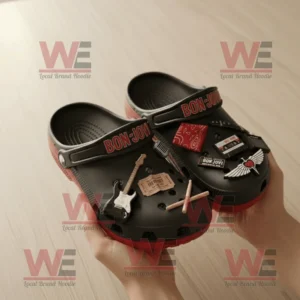 Bon Jovi Crocs Clogs with Charms 8 Bon Jovi themed Crocs held in hands showing intricate music related charms and bright red soles under soft lighting!