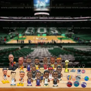 Basketball player figurines displayed on a table in front of the Boston Celtics court background.