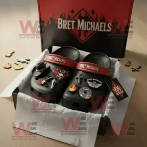 Bret Michaels Crocs Clogs With Charms 7 Bret Michaels themed Crocs neatly arranged in packaging with red straps and various music and skull inspired charms on a wooden surface!