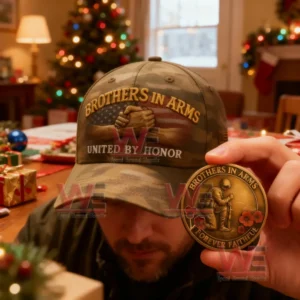 A camouflage hat with Brothers in Arms United by Honor text and a bronze coin reading Brothers in Arms Forever Faithful held in a Christmas decorated room.