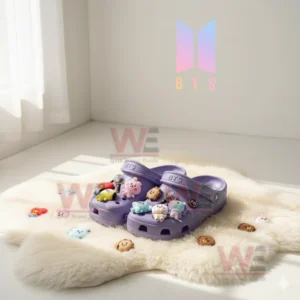 BTS-themed Crocs with BT21 character charms on a soft background.