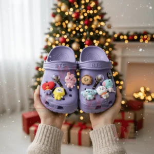BTS Band Crocs Crocband Clogs 4 Hands holding BTS-themed Crocs with BT21 charms in front of a Christmas tree.
