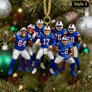A Christmas ornament featuring Buffalo Bills players hanging from a golden string with holiday lights and tree branches in the background.