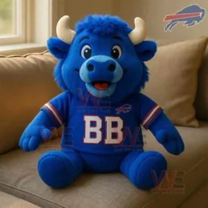 Blue buffalo plush toy wearing a Buffalo Bills BB shirt sitting on a beige sofa near a window.