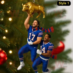 A festive Christmas ornament showing two football players lifting a golden buffalo together with a decorated tree in the background.