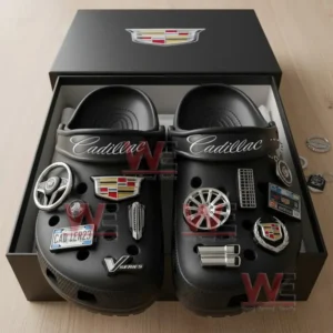 Black clogs inside a box featuring various Cadillac themed charms attached to the front!