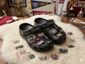 Black clogs on a fuzzy surface surrounded by various Cadillac themed charms in a decorated room!