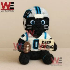 A crochet football mascot doll in blue and white gear holding a football and a keep pounding sign showing support and motivation!