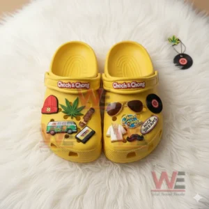 Yellow clogs featuring multiple charms resting on a white furry surface.