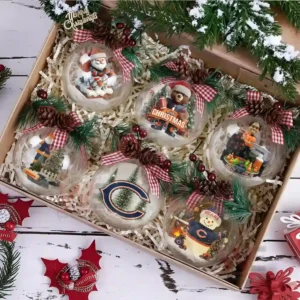 A gift box holding six decorated Chicago Bears Christmas ornaments arranged neatly with festive greenery and ribbons.