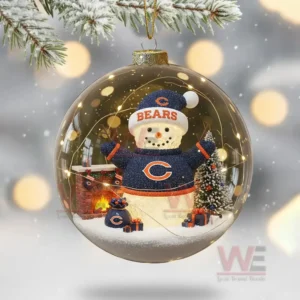 A clear ornament with a Chicago Bears snowman scene including a fireplace tree and presents inside.