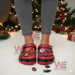 Red clogs with firefighter charms worn by a person in a holiday themed environment!