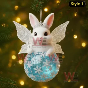 A white rabbit ornament with sparkling wings perched on a blue snowflake ball in front of soft yellow holiday lights!