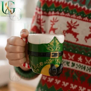 Christmas elf themed mug with detailed green and gold design held by person wearing holiday sweater!