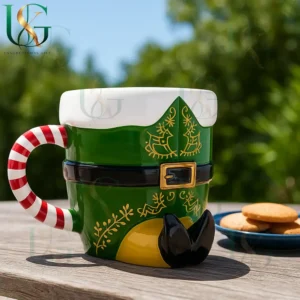 Elf outfit Christmas mug with candy cane handle and cookies on outdoor table in sunny setting!