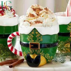 Elf costume Christmas mug topped with whipped cream surrounded by festive decorations and sweets!
