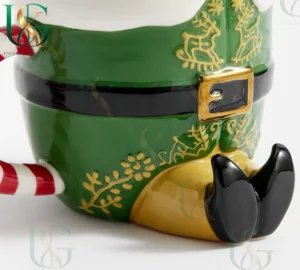 Close up of elf style Christmas mug showing gold patterns and belt details with festive design!