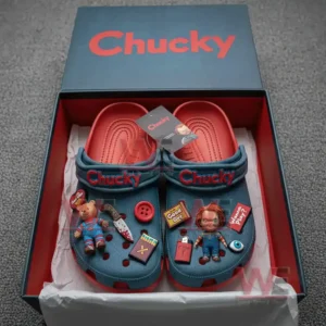 Alt text: Chucky-themed crocs with various charms displayed in a box, showing a doll, knife, button, and brand tag.